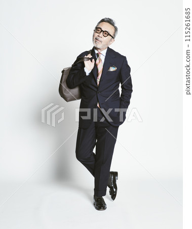 Middle-aged businessman holding a bag on a white background 115261685