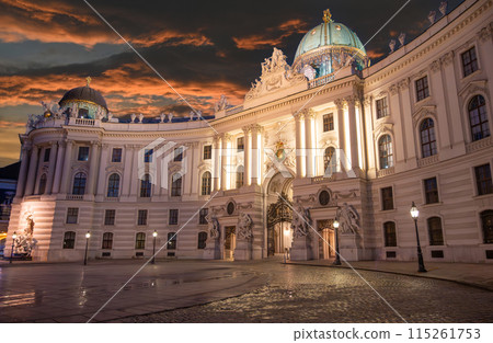 Vienna, Austria, August 17, 2022. Magnificent night view of the Hofburg Imperial Palace, the illumination enhances the imposing facade. People in the square. 115261753