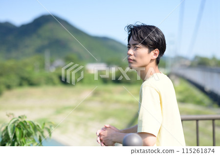 Man resting on a bridge 115261874