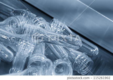 Close up scene piles of preform shape of PET bottle products. Close up scene piles of preform shape of PET bottle products. 115261902