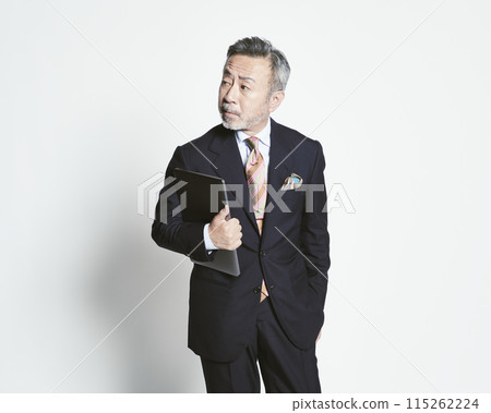 Middle-aged businessman holding a PC on a white background (upper body) 115262224