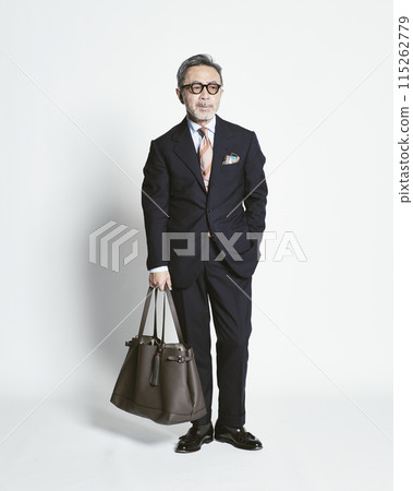 Middle-aged businessman holding a bag on a white background Middle-aged businessman holding a bag on a white background 115262779