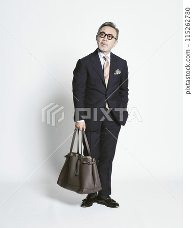 Middle-aged businessman holding a bag on a white background 115262780