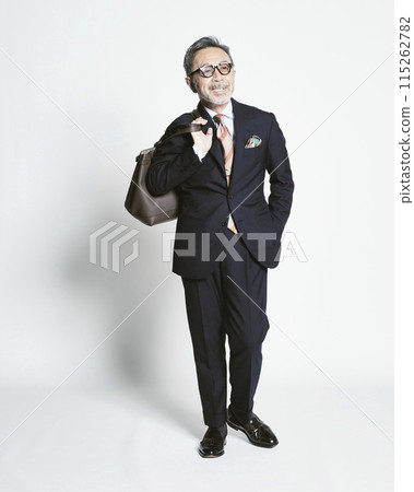 Middle-aged businessman holding a bag on a white background 115262782