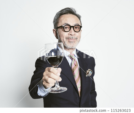 Middle-aged businessman holding a wine glass on a white background 115263023