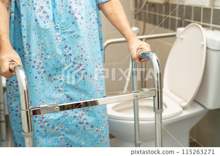 Asian elderly woman patient use walker and toilet bathroom handle security in nursing hospital, healthy strong medical. 115263271