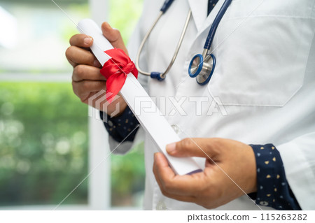 Asian doctor study learn with graduation gap hat in hospital ward, clever bright genius education medicine concept. Asian doctor study learn with graduation gap hat in hospital ward, clever bright genius education medicine concept. 115263282