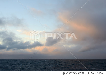 Calm Ocean at Sunset with Dramatic Clouds Calm Ocean at Sunset with Dramatic Clouds 115263457