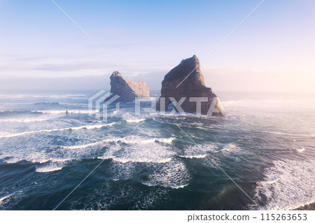 Sunrise shining over Wharariki beach and archway island on Tasman sea at New Zealand Sunrise shining over Wharariki beach and archway island on Tasman sea at New Zealand 115263653