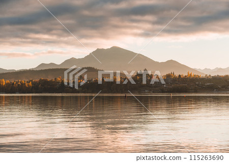 Scenery of sunrise over mountain range and autumn forest on Lake Wanaka Scenery of sunrise over mountain range and autumn forest on Lake Wanaka 115263690