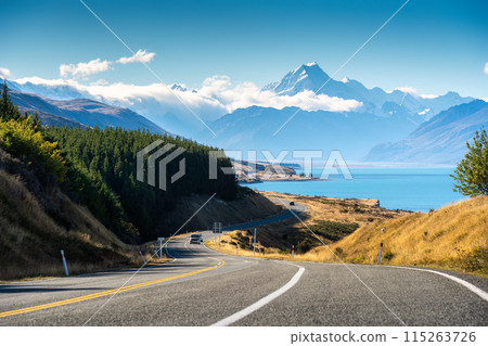 Scenic road trip of Mt Cook over winding road and Lake Pukaki on sunny day at New Zealand 115263726