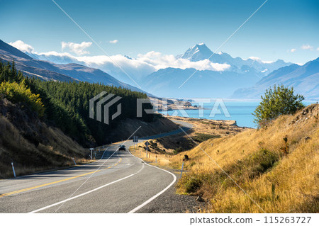 Scenic road trip of Mt Cook over winding road and Lake Pukaki on sunny day at New Zealand 115263727