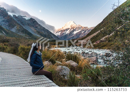 Hooker valley track with female tourist enjoying on trail and mount cook at New Zealand 115263733