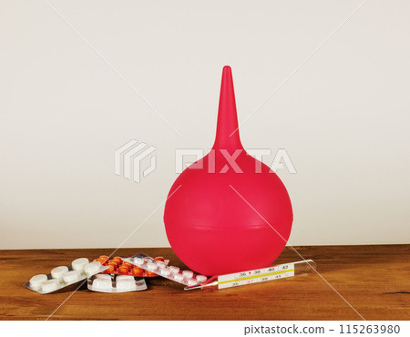 Thermometer with pills and rubber bulb to clean the colon 115263980