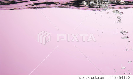 Different waves of air bubbles caused by falling water on a colorful background. 115264390