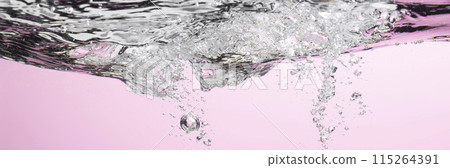 Different waves of air bubbles caused by falling water on a colorful background. Different waves of air bubbles caused by falling water on a colorful background. 115264391
