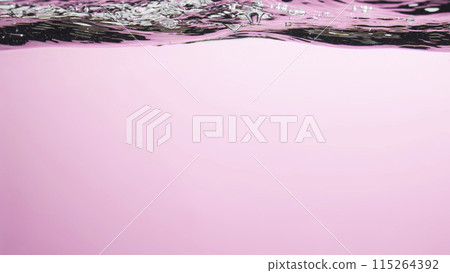 Different waves of air bubbles caused by falling water on a colorful background. 115264392