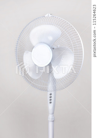 Electric Floor fan white isolated on beige background. Relief Help from the heat, hot summer. Close up vertical 115264623