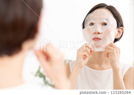 Woman applying face mask, beauty, skin care 115265264