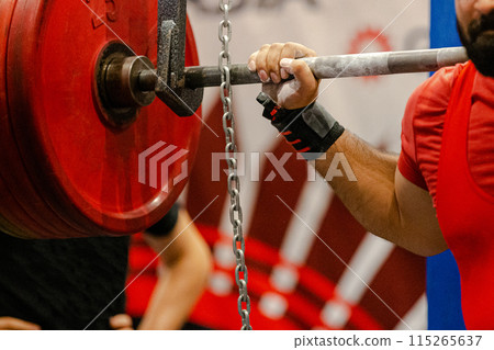 man powerlifter starting squat exercise at powerlifting competition 115265637