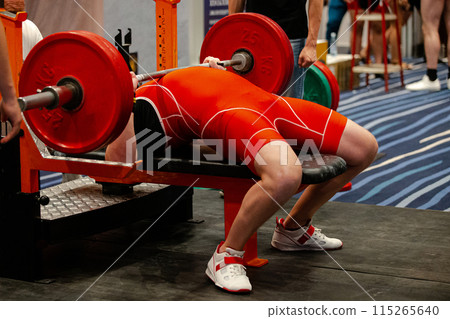 bench press athlete in powerlifting competition, barbell weight 120 kg 115265640