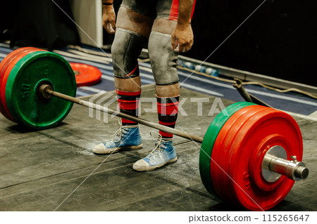athlete deadlift exercise at powerlifting competition, legs and knee pads in magnesia 115265647
