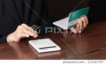 Senior woman in mourning clothes looking at bankbook, lonely, hand Senior woman in mourning clothes looking at bankbook, lonely, hand 115265767