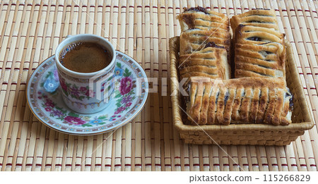 A cup of fresh coffee and puff with berries 115266829