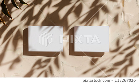 Close up of white business cards mock up, template for design copy space. With warm sunny light and shadows overlay.1 115267020