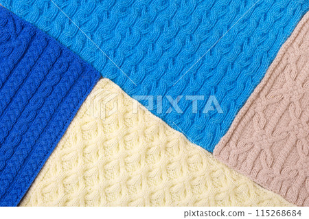 Knitted blue, yellow and beige background. Large knitted fabric with a pattern. Close-up of a knitted blanket. Mockup for special offers as advertising or other ideas Knitted blue, yellow and beige background. Large knitted fabric with a pattern. Close-up of a knitted blanket. Mockup for special offers as advertising or other ideas 115268684