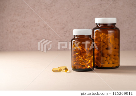 White pills and omega 3 pills, in brown and transparent jar, food supplements, drugs, antibiotics. 115269011