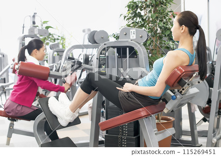 Women exercising at fitness gym Women exercising at fitness gym 115269451