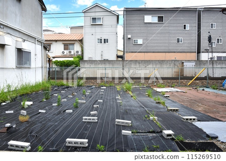 Vacant lot covered with weed control sheet Vacant lot covered with weed control sheet 115269510