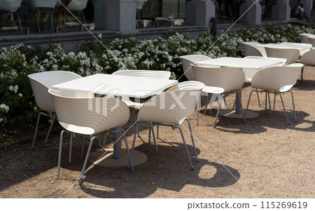 Outdoor street cafe tables ready for service. Modern Empty cafe terrace with table and chair, morning time. Food concept. Cafeteria, Outside Trattoria Outdoor street cafe tables ready for service. Modern Empty cafe terrace with table and chair, morning time. Food concept. Cafeteria, Outside Trattoria 115269619