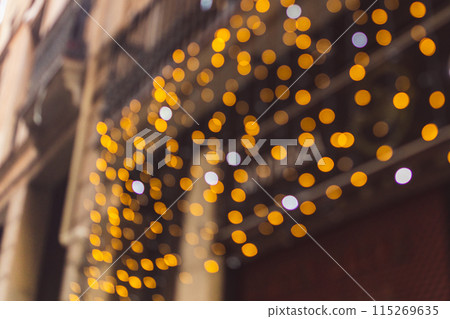 Decorative outdoor string lights at night time, Defocused Background, night city life backdrop, party time with Yellow bokeh balls Decorative outdoor string lights at night time, Defocused Background, night city life backdrop, party time with Yellow bokeh balls 115269635