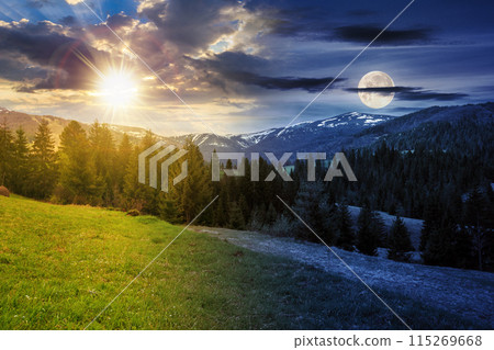 landscape with grassy meadow and spruce forest on the hill in mountainous area with sun and moon on the sky. day and night time change concept on spring equinox. mysterious scenery in morning light 115269668