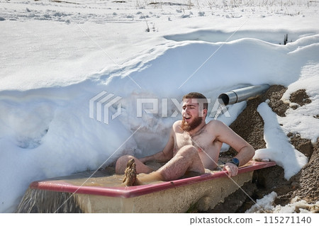 Guy taking cold plunge in a snowy bathtub Guy taking cold plunge in a snowy bathtub 115271140