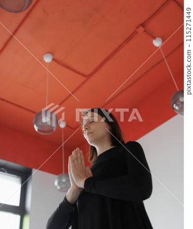 woman meditates and practices yoga, hands above her head woman meditates and practices yoga, hands above her head 115271449