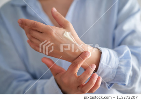 Hands in a blue shirt smear cream. Hands in a blue shirt smear cream. 115272207