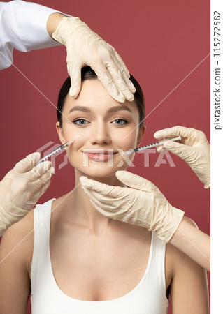 The doctor injects botox to a young girl The doctor injects botox to a young girl 115272582