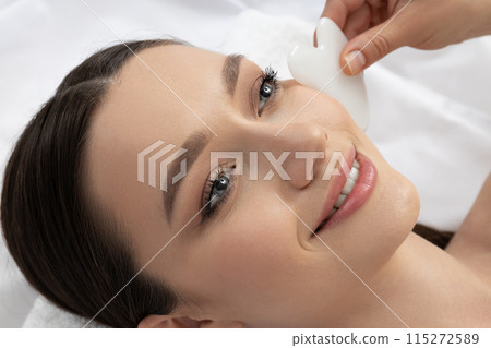 An attractive brunette at an appointment with a beautician 115272589