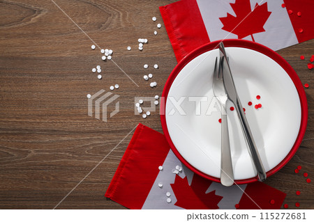 Cutlery with flag of Canada on wooden background 115272681