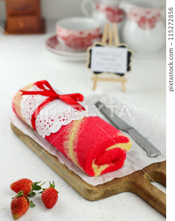Strawberry Sponge Roll served on a wooden plate Strawberry Sponge Roll served on a wooden plate 115272856