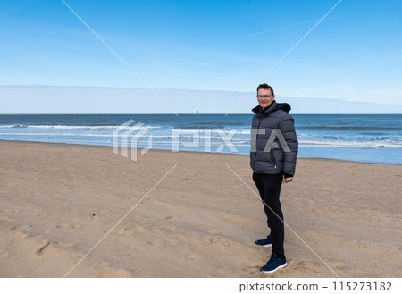 40 yo white man standing on the beach of Knokke, Flanders, Belgium 40 yo white man standing on the beach of Knokke, Flanders, Belgium 115273182