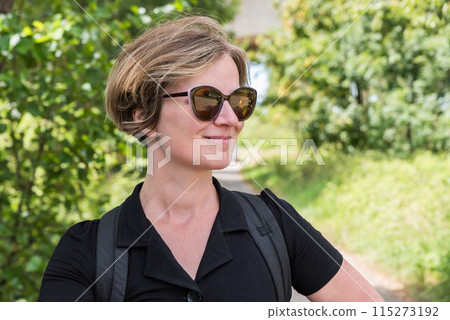 Picture of a relaxed attractive woman in the shadows of the woods, Kordel, Germany 115273192