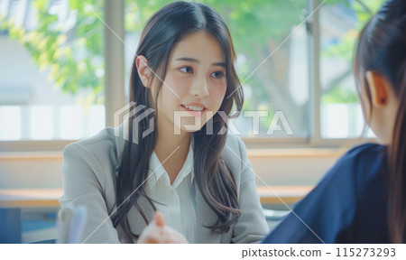 School counselor giving advice to high school girls_5 115273293