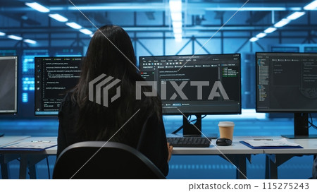 IT support employee in data center putting headphones on to talk with coworkers, coding on computer. Woman in remote call meeting with colleagues using headset microphone, overseeing server clusters 115275243
