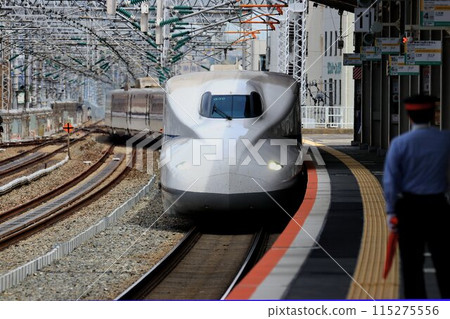 The Sanyo Shinkansen [N700 Series A] swiftly runs through Nishi-Akashi Station on the Sanyo Line 115275556