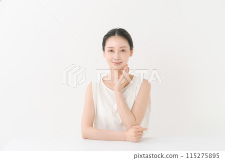 woman smiling with hand on cheek 115275895