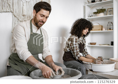 Man and woman creating pottery at pottery workshop Man and woman creating pottery at pottery workshop 115276329